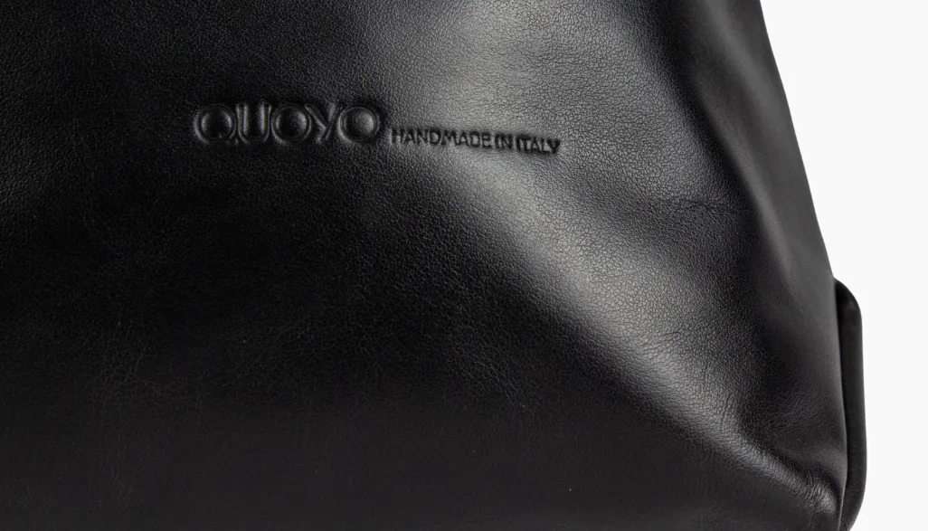 Finished black leather QUOYO bag showing texture and finish